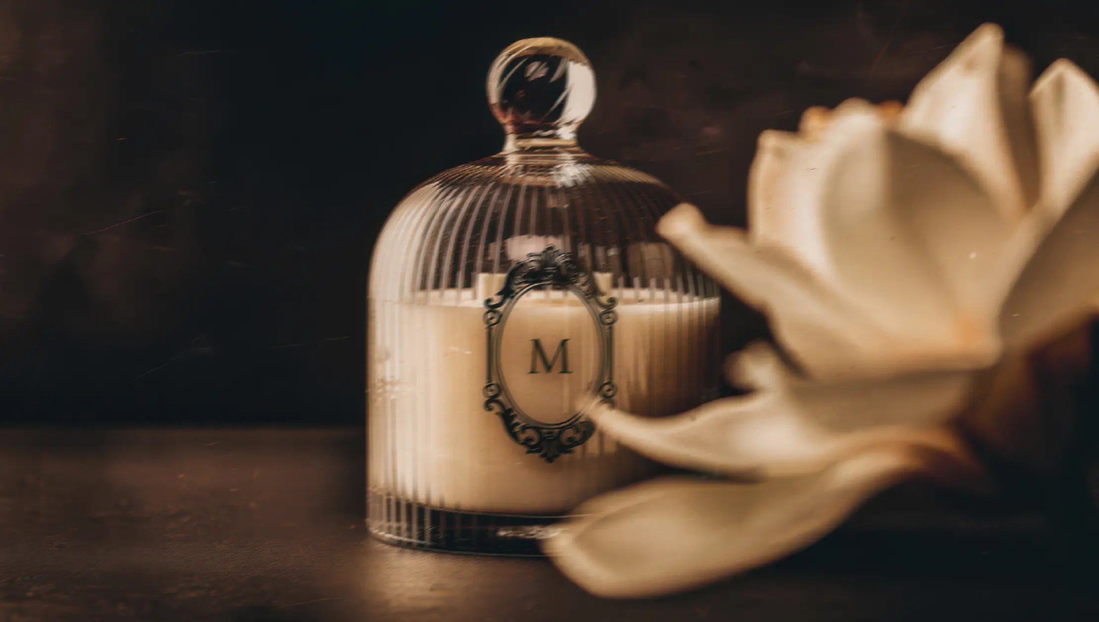 Maison Petal luxury candle with branded monogram label in glass dome packaging