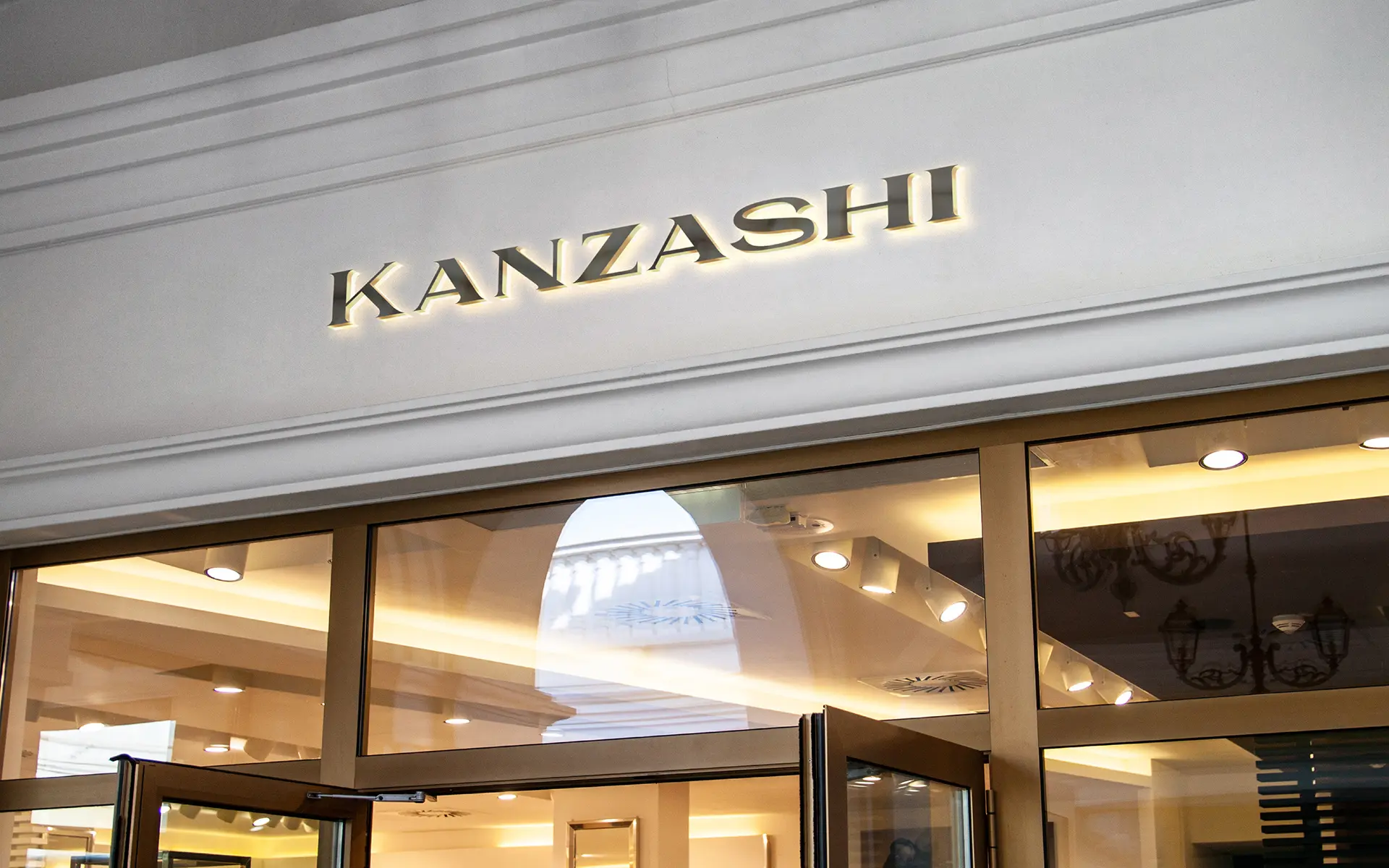 Kanzashi jewelry brand identity applied to luxury retail store signage showing logotype in architectural context