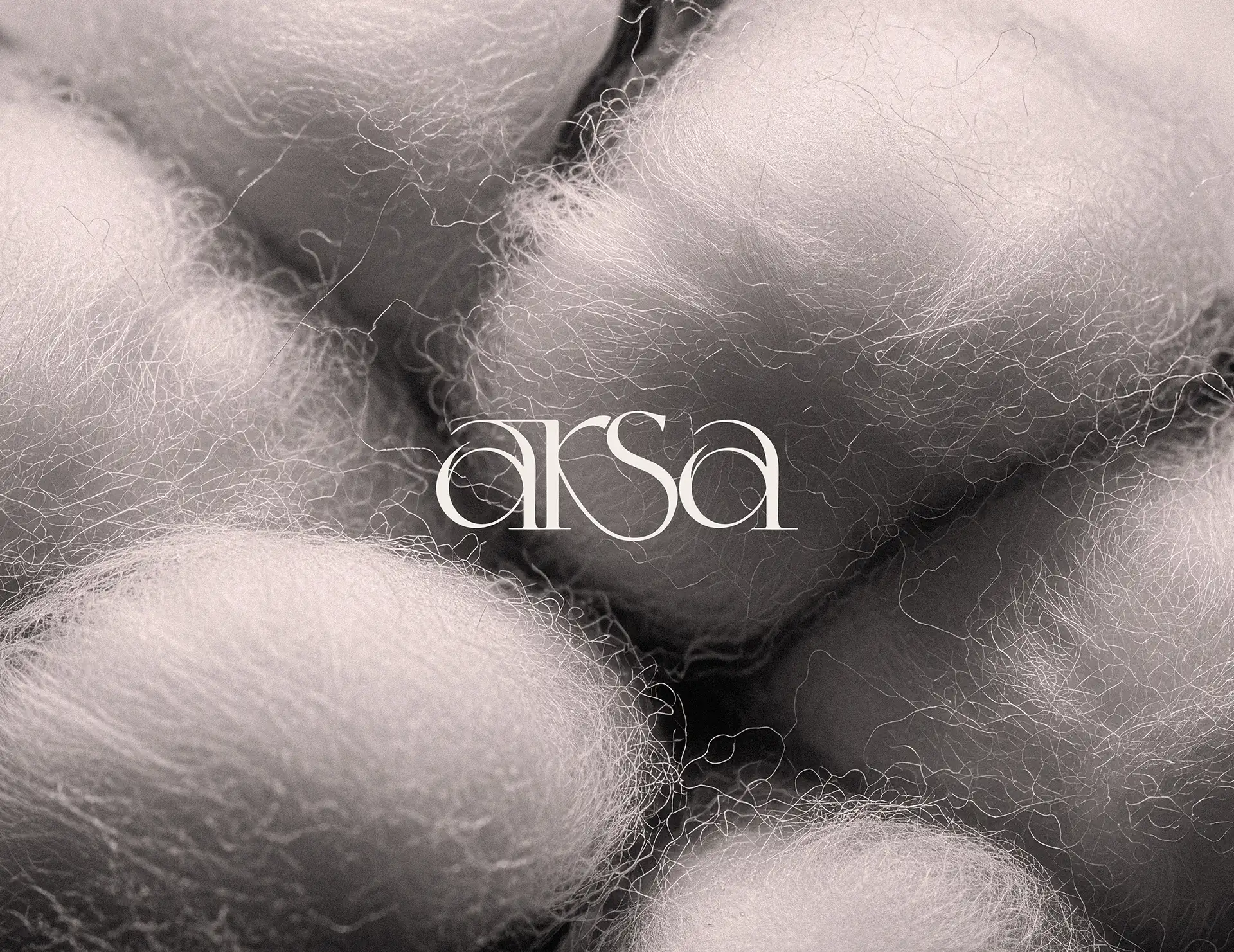 Arsa clothing brand logo applied over natural wool texture showing brand identity in material context